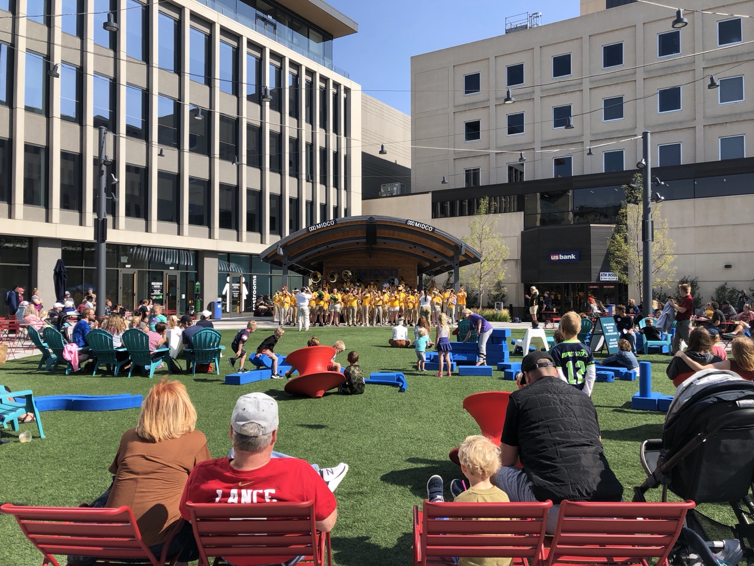 Families and children gathered for a performance in a lively Fargo civic plaza