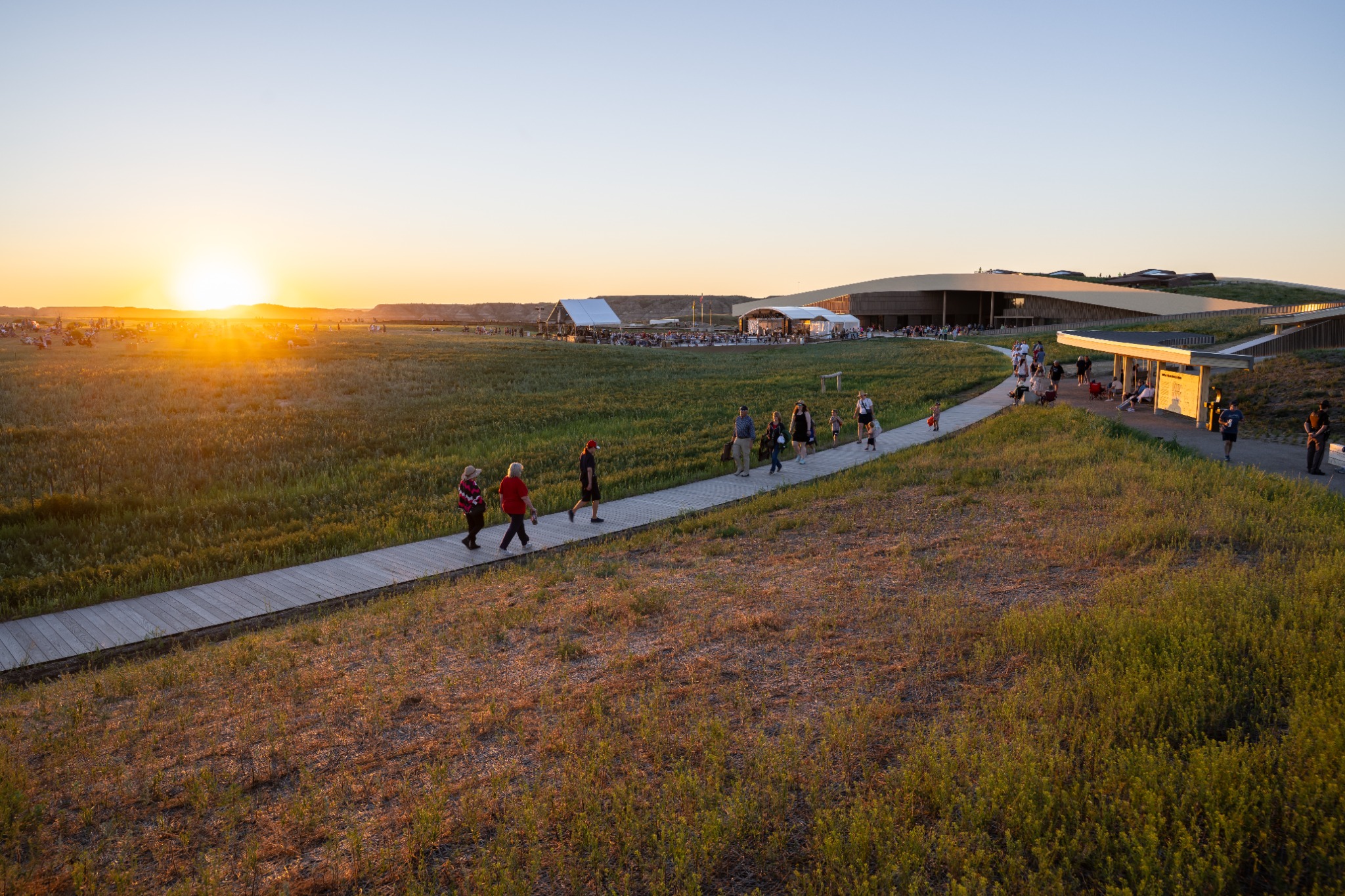 The Library at sunset, with visitors on its winding boardwalk.