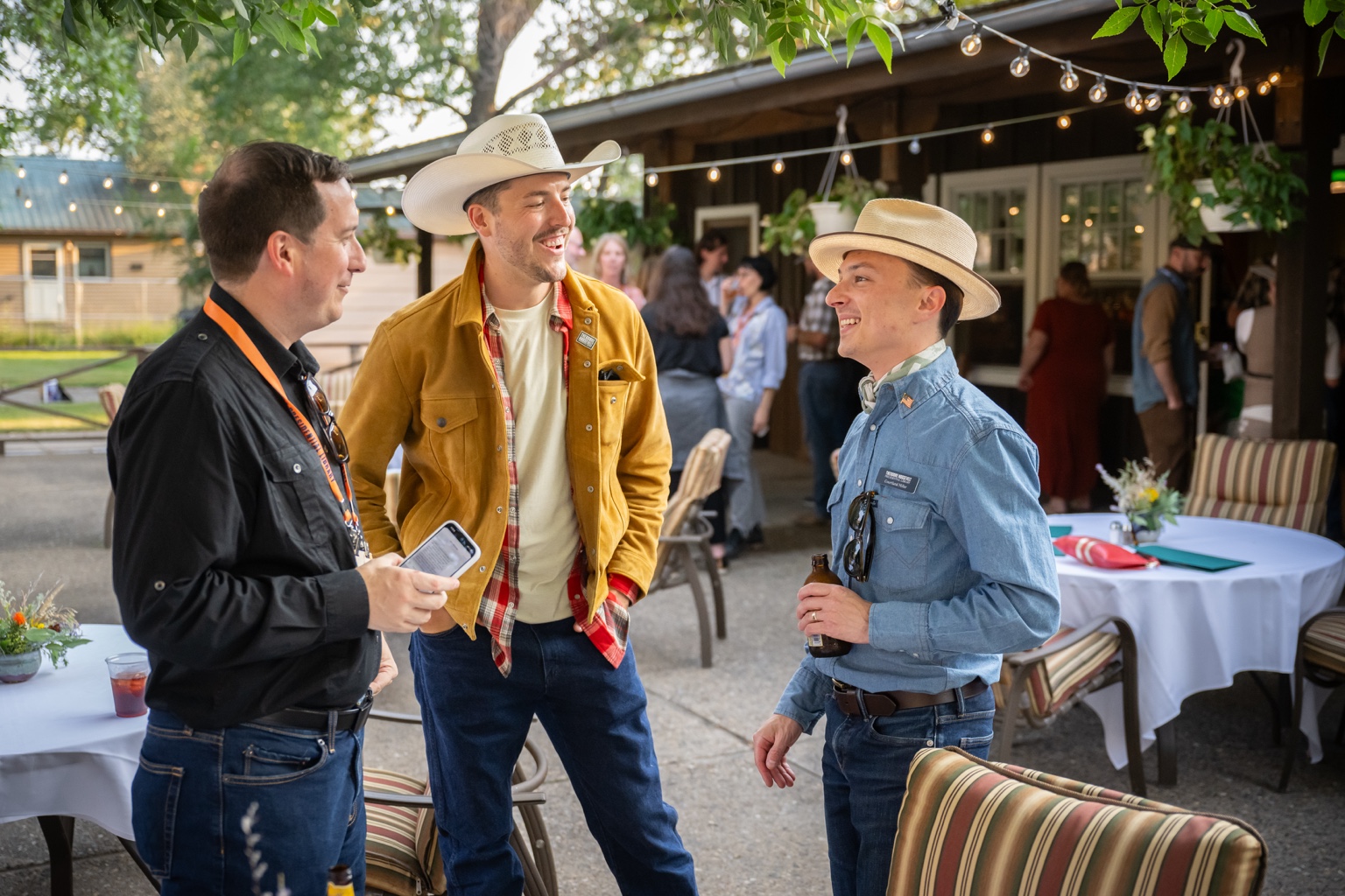 Courtland Miller sharing a conversation with partners at an outdoor gathering